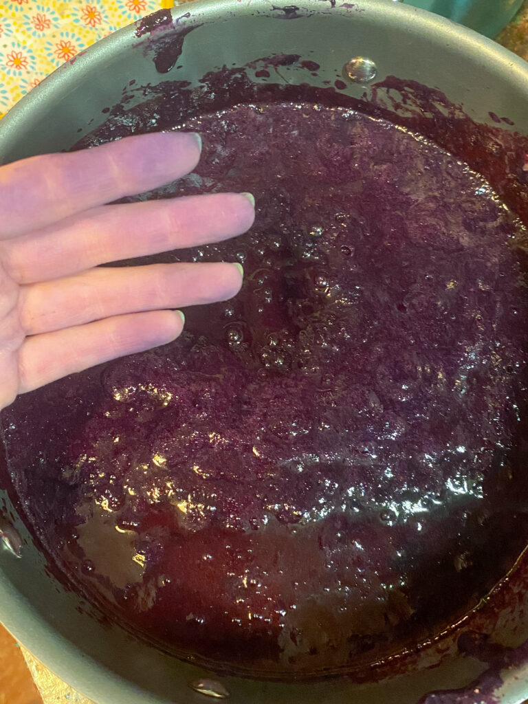 Purple fingers that got dyed from grapes when juicing